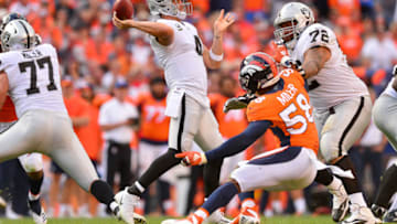 DENVER, CO - SEPTEMBER 16: Quarterback Derek Carr #4 of the Oakland Raiders passes under pressure by linebacker Von Miller #58 of the Denver Broncos at Broncos Stadium at Mile High on September 16, 2018 in Denver, Colorado. (Photo by Dustin Bradford/Getty Images)