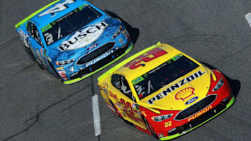 MARTINSVILLE, VA - OCTOBER 28: Joey Logano, driver of the #22 Shell Pennzoil Ford, leads Kevin Harvick, driver of the #4 Busch Beer Ford, during the Monster Energy NASCAR Cup Series First Data 500 at Martinsville Speedway on October 28, 2018 in Martinsville, Virginia. (Photo by Sean Gardner/Getty Images)
