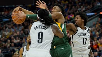 SALT LAKE CITY, UT - MARCH 16: Donovan Mitchell #45 of the Utah Jazz fights for the ball with DeMarre Carroll #9 and Ed Davis #17 of the Brooklyn Nets during a game at Vivint Smart Home Arena on March 16, 2019 in Salt Lake City, Utah. (Photo by Alex Goodlett/Getty Images)