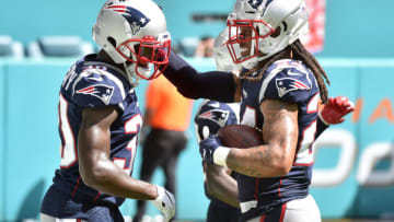 MIAMI, FL - SEPTEMBER 15: Stephon Gilmore #24 of the New England Patriots is congratulated by Jason McCourty #30 after returning a touchdown in the fourth quarter against the Miami Dolphins at Hard Rock Stadium on September 15, 2019 in Miami, Florida. (Photo by Eric Espada/Getty Images)