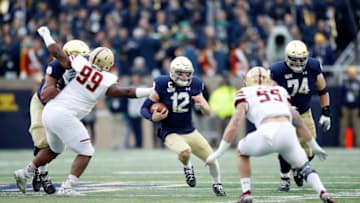 SOUTH BEND, IN - NOVEMBER 23: Ian Book #12 of the Notre Dame Fighting Irish runs with the ball during a game against the Boston College Eagles at Notre Dame Stadium on November 23, 2019 in South Bend, Indiana. Notre Dame defeated Boston College 40-7. (Photo by Joe Robbins/Getty Images)