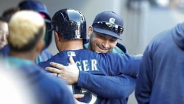 Oct 2, 2016; Seattle, WA, USA; Seattle Mariners catcher Mike Zunino (facing camera) hugs third baseman Kyle Seager (15) during the ninth inning against the Oakland Athletics at Safeco Field. Oakland won 3-2. Mandatory Credit: Jennifer Buchanan-USA TODAY Sports