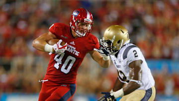 BOCA RATON, FL - SEPTEMBER 1: Harrison Bryant #40 of the Florida Atlantic Owls is defended by Jarid Ryan #2 of the Navy Midshipmen as he runs with the ball on September 1, 2017 at FAU Stadium in Boca Raton, Florida. (Photo by Joel Auerbach/Getty Images)