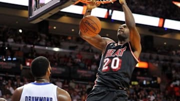 Feb 3, 2014; Miami, FL, USA; Miami Heat center Greg Oden (20) dunks the ball as Detroit Pistons center Andre Drummond (0) looks on during the second half at American Airlines Arena. Mandatory Credit: Steve Mitchell-USA TODAY Sports