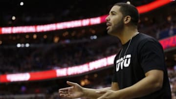 Apr 24, 2015; Washington, DC, USA; Rapper Drake looks on from courtside during the game between the Washington Wizards and the Toronto Raptors in game three of the first round of the NBA Playoffs at Verizon Center. The Wizards won 106-99, and lead the series 3-0. Mandatory Credit: Geoff Burke-USA TODAY Sports
