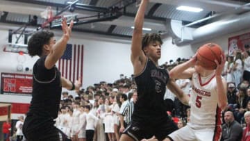 Menomonee Falls guard Evan Redding, left, and Seth Trimble trap Sussex Hamilton guard Aidan Konop during a game on Dec. 10, 2021.Ctk17134