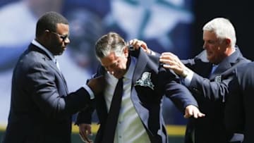Aug 8, 2015; Seattle, WA, USA; Former Seattle Mariners Ken Griffey Jr. (left) and Lou Piniella (right) help pitcher Jamie Moyer into his new Mariners Hall of Fame jacket before the start of a game against the Texas Rangers at Safeco Field. Mandatory Credit: Jennifer Buchanan-USA TODAY Sports