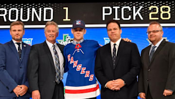 Jun 22, 2018; Dallas, TX, USA; Nils Lundkvist poses for a photo with team representatives after being selected as the number twenty-eight overall pick to the New York Rangers in the first round of the 2018 NHL Draft at American Airlines Center. Mandatory Credit: Jerome Miron-USA TODAY Sports
