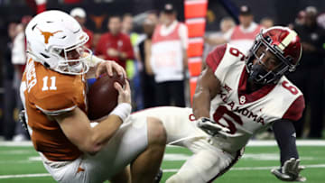 ARLINGTON, TEXAS - DECEMBER 01: Sam Ehlinger #11 of the Texas Longhorns is tackled by Tre Brown #6 of the Oklahoma Sooners for a safety in the fourth quarter at AT&T Stadium on December 01, 2018 in Arlington, Texas. (Photo by Ronald Martinez/Getty Images)