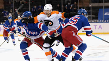 NEW YORK, NEW YORK - MARCH 15: Scott Laughton #21 of the Philadelphia Flyers attempts to get past Brett Howden #21 and Libor Hajek #25 of the New York Rangers at Madison Square Garden on March 15, 2021 in New York City. The Flyers defeated the Rangers 5-4 in overtime. (Photo by Bruce Bennett/Getty Images)