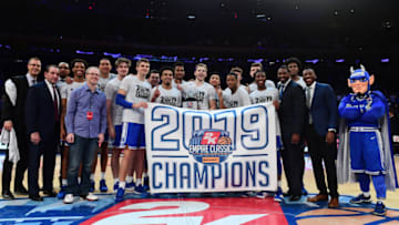 NEW YORK, NEW YORK - NOVEMBER 22: The Duke Blue Devils pose with their 2K Empire Classic tournament trophy after a 81-73 win over the Georgetown Hoyas at Madison Square Garden on November 22, 2019 in New York City. (Photo by Emilee Chinn/Getty Images)
