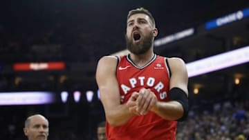 OAKLAND, CA - DECEMBER 12: Jonas Valanciunas #17 of the Toronto Raptors grimaces in pain after hurting his finger against the Golden State Warriors at ORACLE Arena on December 12, 2018 in Oakland, California. NOTE TO USER: User expressly acknowledges and agrees that, by downloading and or using this photograph, User is consenting to the terms and conditions of the Getty Images License Agreement. (Photo by Ezra Shaw/Getty Images)