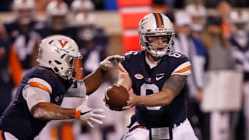 CHARLOTTESVILLE, VA - NOVEMBER 24: Virginia runningback Jordan Ellis (1) prepares to receive the ball from quarterback Kurt Benkert (6) in the backfield during a game between the Virginia Tech Hokies and the Virginia Cavaliers on November 24, 2017 at Scott Stadium in Charlottesville, VA. (Photo by Lee Coleman/Icon Sportswire via Getty Images)