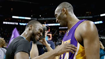 CHARLOTTE, NC - DECEMBER 28: Kemba Walker #15 of the Charlotte Hornets talks to Kobe Bryant #24 of the Los Angeles Lakers after the Hornets defeated the Lakers 108-98 at Time Warner Cable Arena on December 28, 2015 in Charlotte, North Carolina. NOTE TO USER: User expressly acknowledges and agrees that, by downloading and or using this photograph, User is consenting to the terms and conditions of the Getty Images License Agreement. (Photo by Streeter Lecka/Getty Images)