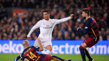 BARCELONA, SPAIN - APRIL 02: Cristiano Ronaldo of Real Madrid CF attempts to shoot under pressure from Javier Mascherano and Gerard Pique of FC Barcelona during the La Liga match between FC Barcelona and Real Madrid CF at Camp Nou on April 2, 2016 in Barcelona, Spain. (Photo by Alex Caparros/Getty Images)