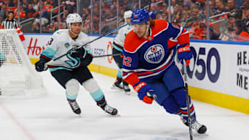 Oct 6, 2023; Edmonton, Alberta, CAN; Edmonton Oilers forward Raphael Lavoie (62) protects the puck from Seattle Kraken defensemen Brian Dumoulin (8) during the first period at Rogers Place. Mandatory Credit: Perry Nelson-USA TODAY Sports