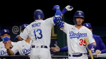 ARLINGTON, TEXAS - OCTOBER 13: Max Muncy #13 of the Los Angeles Dodgers is congratulated by Cody Bellinger after hitting a two run home run against the Atlanta Braves during the ninth inning in Game Two of the National League Championship Series at Globe Life Field on October 13, 2020 in Arlington, Texas. (Photo by Ronald Martinez/Getty Images)