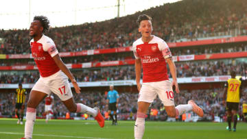 LONDON, ENGLAND - SEPTEMBER 29: Mesut Ozil of Arsenal (r) celebrates scoring his sides second goal with Alex Iwobi during the Premier League match between Arsenal FC and Watford FC at Emirates Stadium on September 29, 2018 in London, United Kingdom. (Photo by Catherine Ivill/Getty Images)