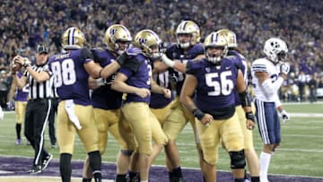 SEATTLE, WA - SEPTEMBER 29: Washington's (3) Jake Browning (QB) is congratulated by teammates after scoring a touchdown during second quarter action between the Washington Huskies and the BYU Cougars on September 29, 2018 at Husky Stadium in Seattle, WA. (Photo by Jesse Beals/Icon Sportswire via Getty Images)