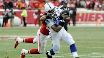 Dec 22, 2013; Kansas City, MO, USA; Indianapolis Colts running back Trent Richardson (34) is tackled by Kansas City Chiefs inside linebacker Derrick Johnson (56) in the first half at Arrowhead Stadium. Mandatory Credit: John Rieger-USA TODAY Sports