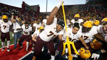 TUCSON, AZ - NOVEMBER 24: Offensive lineman Steven Miller #71 of the Arizona State Sun Devils drives a pitchfork into the turf as he celebrates with teammates following a 41-40 victory against the Arizona Wildcats during the college football game at Arizona Stadium on November 24, 2018 in Tucson, Arizona. (Photo by Ralph Freso/Getty Images)