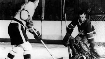 CHICAGO - 1952: Sid Abel of the Chicago Black Hawks takes a shot on goalie Jacques Plante of the Montreal Canadiens during an NHL game circa 1952 at Chicago Stadium in Chicago, Illinois. (Photo by Bruce Bennett Studios via Getty Images Studios/Getty Images)