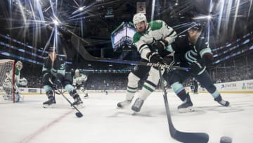 SEATTLE, WASHINGTON - MARCH 11: Jani Hakanpää #2 of the Dallas Stars and Jordan Eberle #7 of the Seattle Kraken play the puck during the third period at Climate Pledge Arena on March 11, 2023 in Seattle, Washington. (Photo by Steph Chambers/Getty Images)