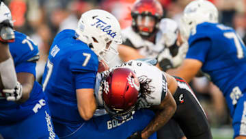 Cincinnati Bearcats linebacker Deshawn Pace sacks Tulsa Golden Hurricane quarterback Davis Brin. USA Today.