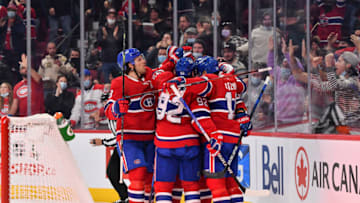 MONTREAL, QC - DECEMBER 07: Nick Suzuki #14 of the Montreal Canadiens celebrates his goal with teammates against the Tampa Bay Lightning during the second period at Centre Bell on December 7, 2021 in Montreal, Canada. (Photo by Minas Panagiotakis/Getty Images)