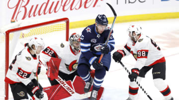 May 8, 2021; Winnipeg, Manitoba, CAN; Winnipeg Jets center Paul Stastny (25) jumps in front of Ottawa Senators goaltender Filip Gustafsson (32) in the third period at Bell MTS Place. Mandatory Credit: James Carey Lauder-USA TODAY Sports
