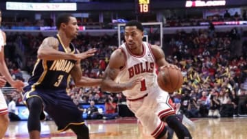Nov 16, 2013; Chicago, IL, USA; Chicago Bulls point guard Derrick Rose (1) drives around Indiana Pacers point guard George Hill (3)during the second half at the United Center. Chicago won 110-94. Mandatory Credit: Dennis Wierzbicki-USA TODAY Sports