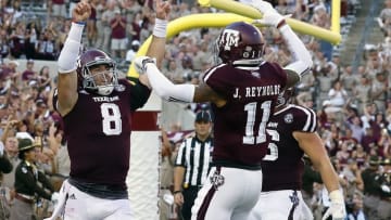 Sep 3, 2016; College Station, TX, USA; Texas A&M Aggies quarterback Trevor Knight (8) points skyward following his one-yard touchdown run in overtime against the UCLA Bruins. Texas A&M won 31-24. Mandatory Credit: Ray Carlin-USA TODAY Sports