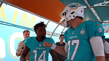 Jan 3, 2016; Miami Gardens, FL, USA; Miami Dolphins wide receiver Jarvis Landry (left) talks with Miami Dolphins quarterback Ryan Tannehill (right) before their game against the New England Patriots at Sun Life Stadium. Mandatory Credit: Steve Mitchell-USA TODAY Sports