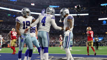 Jan 16, 2022; Arlington, Texas, USA; Dallas Cowboys quarterback Dak Prescott (4) celebrates his touchdown against the San Francisco 49ers with teammates on the field during the second half of the NFC Wild Card playoff football game at AT&T Stadium. Mandatory Credit: Kevin Jairaj-USA TODAY Sports