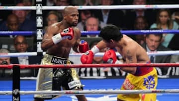 May 2, 2015; Las Vegas, NV, USA; Floyd Mayweather and Manny Pacquiao (Yellow/Red trunks) box during their world welterweight championship bout at MGM Grand Garden Arena. Mandatory Credit: Joe Camporeale-USA TODAY Sports