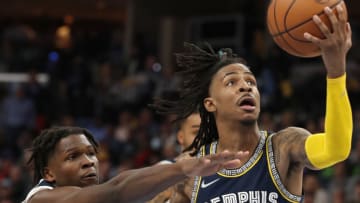 Memphis Grizzlies guard Ja Morant is guarded by Minnesota Timberwolves forward Anthony Edwards. Mandatory Credit: Christine Tannous-USA TODAY Sports