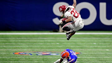Najee Harris (22) jumps over Florida Gators defensive back Kaiir Elam - Adam Hagy-USA TODAY Sports