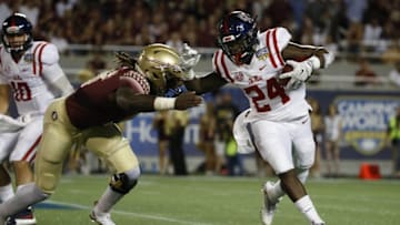Sep 5, 2016; Orlando, FL, USA; Mississippi Rebels running back Eric Swinney (24) runs with the ball as Florida State Seminoles linebacker Dontavious Jackson (5) defends during the first half at Camping World Stadium. Mandatory Credit: Kim Klement-USA TODAY Sports