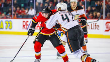 Dec 4, 2016; Calgary, Alberta, CAN; Calgary Flames left wing Johnny Gaudreau (13) and Anaheim Ducks defenseman Hampus Lindholm (47) battle for the puck during the third period at Scotiabank Saddledome. Calgary Flames won 8-3. Mandatory Credit: Sergei Belski-USA TODAY Sports