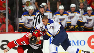 Apr 7, 2016; Chicago, IL, USA; St. Louis Blues right wing Ryan Reaves (75) and Chicago Blackhawks left wing Brandon Mashinter (53) fight during the second period at the United Center. Mandatory Credit: Dennis Wierzbicki-USA TODAY Sports