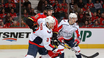 CALGARY, AB - OCTOBER 22: Noah Hanifin #55 of the Calgary Flames and Nick Jensen #3 of the Washington Capitals compete for position during an NHL game on October 22, 2019 at the Scotiabank Saddledome in Calgary, Alberta, Canada. (Photo by Gerry Thomas/NHLI via Getty Images)