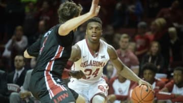 Nov 24, 2015; Norman, OK, USA; Oklahoma Sooners guard Buddy Hield (24) dribbles the ball as Incarnate Word Cardinals forward Kyle Hittle (4) defends during the second half at Lloyd Noble Center. Mandatory Credit: Mark D. Smith-USA TODAY Sports