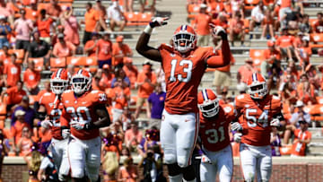 CLEMSON, SC - SEPTEMBER 01: Defensive lineman K.J. Henry #13 of the Clemson Tigers reacts as he runs off the field with teammates safety Nolan Turner #24, linebacker Jalen Williams #30, defensive back Mario Goodrich #31, and defensive end Logan Rudolph #54 after the Tigers force a Furman Paladins fumble during the fourth quarter of the football game at Clemson Memorial Stadium on September 1, 2018 in Clemson, South Carolina. (Photo by Mike Comer/Getty Images)