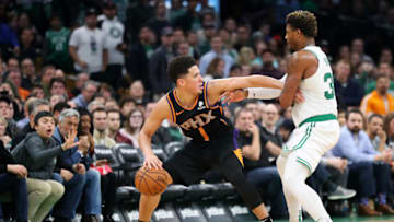 BOSTON, MASSACHUSETTS - DECEMBER 19: Marcus Smart #36 of the Boston Celtics defends Devin Booker #1 of the Phoenix Suns at TD Garden on December 19, 2018 in Boston, Massachusetts. The Suns defeat the Celtics 111-103. NOTE TO USER: User expressly acknowledges and agrees that, by downloading and or using this photograph, User is consenting to the terms and conditions of the Getty Images License Agreement. (Photo by Maddie Meyer/Getty Images)