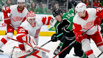 Dec 10, 2022; Dallas, Texas, USA; Detroit Red Wings goaltender Ville Husso (35) and defenseman Gustav Lindstrom (28) and Dallas Stars center Ty Dellandrea (10) look for the puck rebound during the second period at the American Airlines Center. Mandatory Credit: Jerome Miron-USA TODAY Sports