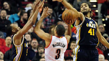 Jan 13, 2016; Portland, OR, USA; Portland Trail Blazers guard C.J. McCollum (3) drives to the basket on Utah Jazz guard Rodney Hood (5) and center Rudy Gobert (27) during the first quarter of the NBA game at the Moda Center at the Rose Quarter. Mandatory Credit: Steve Dykes-USA TODAY Sports