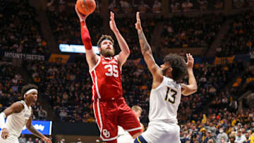 Jan 26, 2022; Morgantown, West Virginia, USA; Oklahoma Sooners forward Tanner Groves (35) shoots over West Virginia Mountaineers forward Isaiah Cottrell (13) during the first half at WVU Coliseum. Mandatory Credit: Ben Queen-USA TODAY Sports