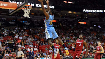Mar 14, 2016; Miami, FL, USA; Denver Nuggets forward Kenneth Faried (35) dunks the ball past Miami Heat forward Luol Deng (9) during the first half at American Airlines Arena. Mandatory Credit: Steve Mitchell-USA TODAY Sports