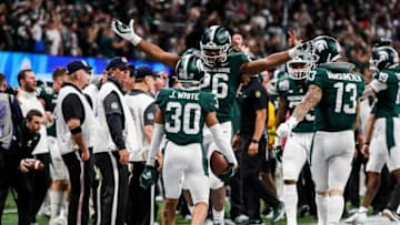 Michigan State cornerback Justin White celebrates a play with defensive end Brandon Wright during the second half of the 31-21 win over Pittsburgh in the Peach Bowl at the Mercedes-Benz Stadium in Atlanta on Thursday, Dec. 30, 2021.