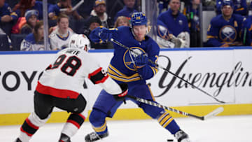 Feb 17, 2022; Buffalo, New York, USA; Buffalo Sabres defenseman Rasmus Dahlin (26) plays the puck between his legs as Ottawa Senators defenseman Victor Mete (98) defends during the second period at KeyBank Center. Mandatory Credit: Timothy T. Ludwig-USA TODAY Sports